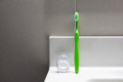 Toothbrush and floss on a counter