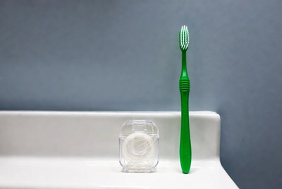 Green toothbrush and dental floss container
