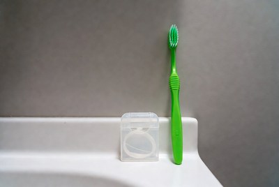 Green toothbrush and dental floss container