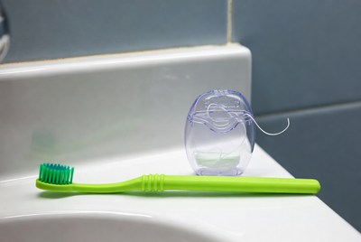Toothbrush and floss on counter