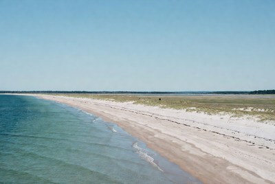 Shoreline with blue water and sand