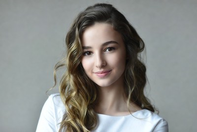 Young woman smiles in indoor setting