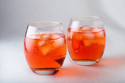 Two glasses with orange drink and ice