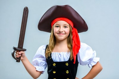 Young pirate girl poses confidently for photo