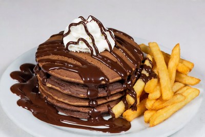 Chocolate pancakes with fries on a plate
