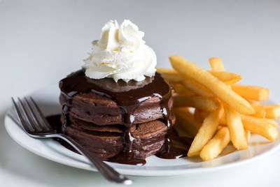 Chocolate pancakes with fries on plate