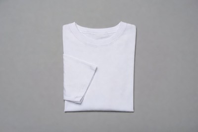 Folded white t-shirt on gray surface