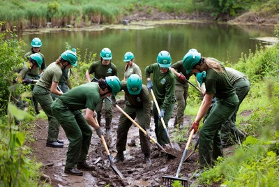 Volunteers working to clear the pond