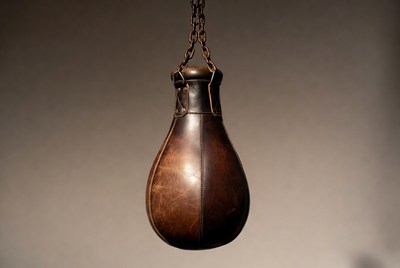 Vintage leather punching bag hanging