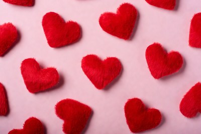 Red fuzzy hearts on pink background