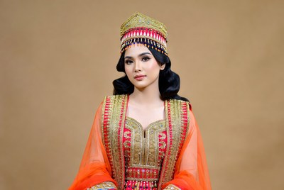 Woman in traditional dress poses in studio
