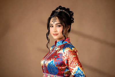 Woman in vibrant traditional dress poses