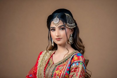Woman in traditional attire poses indoors