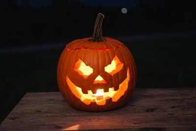 Carved pumpkin lit at night