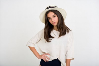 Young girl posing with hat