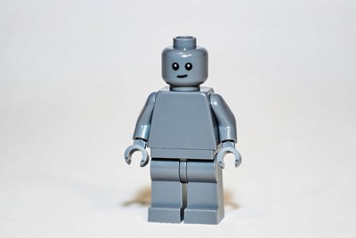 Gray lego robot figure on a light background