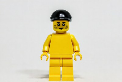 Yellow lego figure with black cap