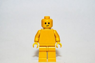 Yellow toy figure standing straight