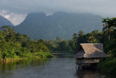 Hut by the river in mountains