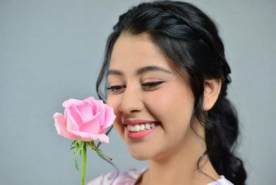 Woman smiling with pink rose