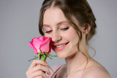 Woman holding a rose with smile