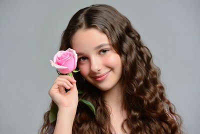 Girl holding a pink rose