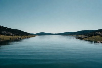 View of lake and hills under clear sky