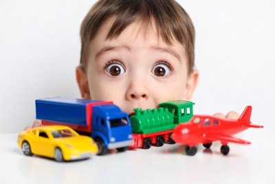 Boy plays with toy vehicles