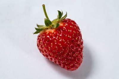 Fresh strawberry on white surface