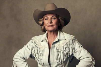 Woman in western attire poses confidently