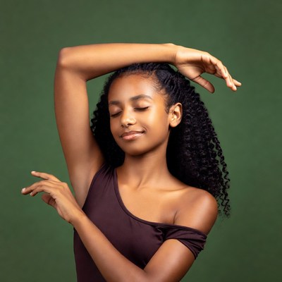 Young dancer poses under green background