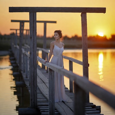 Woman on a dock at sunset