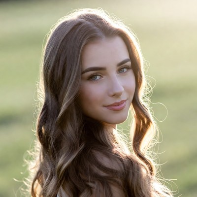 Woman with long hair outdoors in sunlight