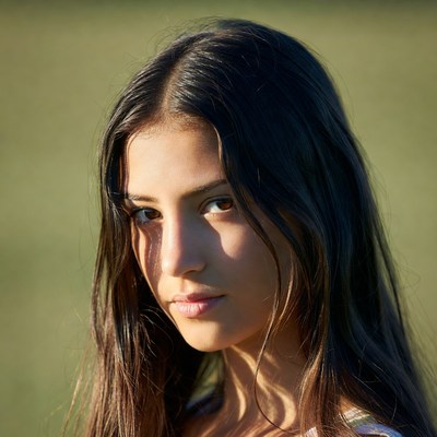 Young woman looking at camera outdoors