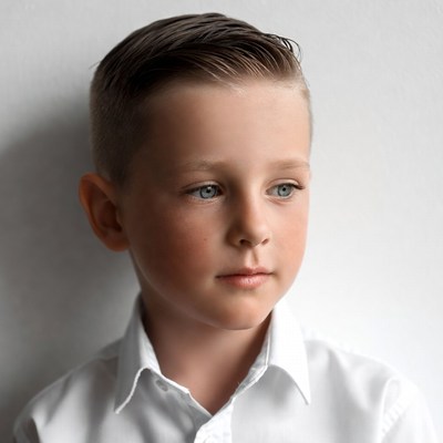 Boy in white shirt poses for portrait