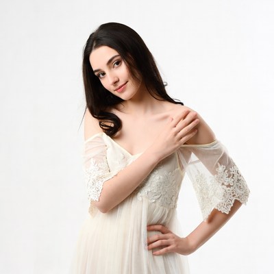Model wearing white dress poses for camera