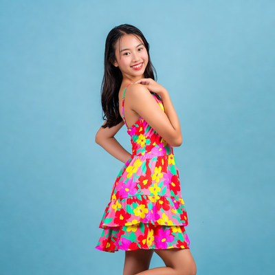 Young girl poses in colorful dress