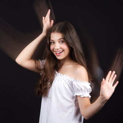 Girl with hands raised in motion