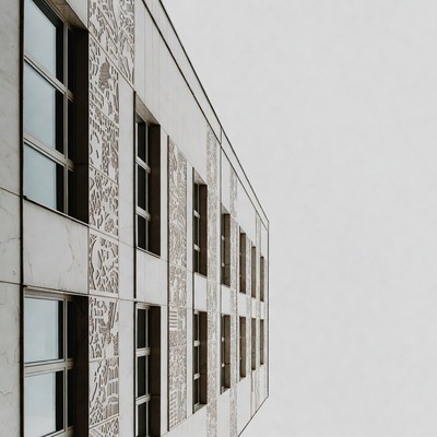 Building with patterned facade in cloudy sky