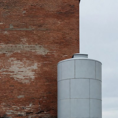 Rusty brick wall with gray tank