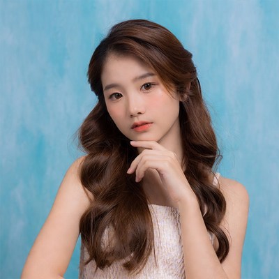 Model posing in front of blue background