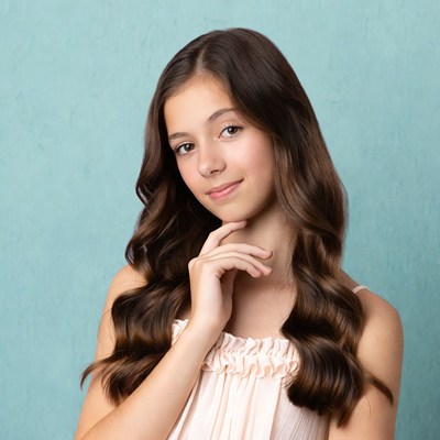 Girl poses with soft smile indoors