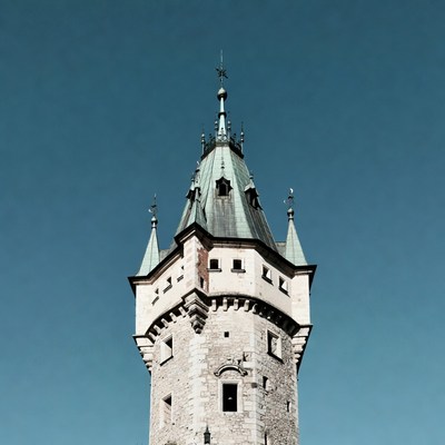 Historic tower stands against blue sky