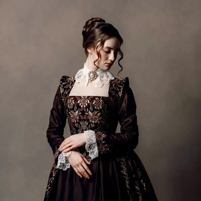 Woman in dark dress poses quietly