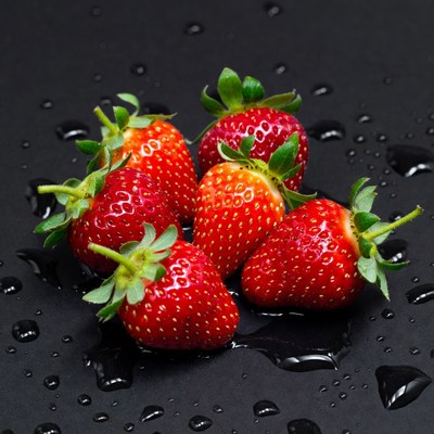 Red strawberries on dark surface