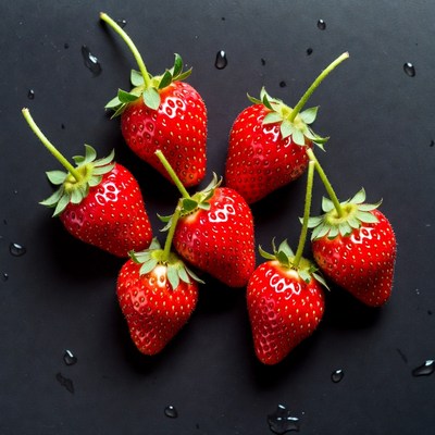 Fresh strawberries on a dark surface