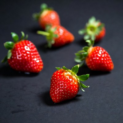 Fresh strawberries on dark surface