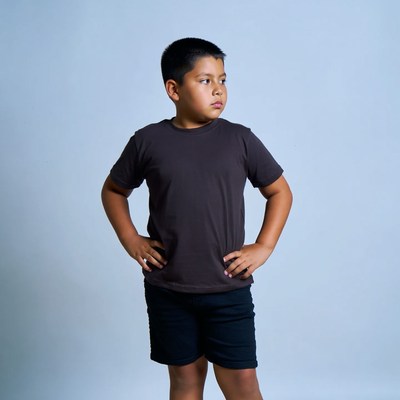 Boy posing with hands on hips