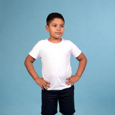 Boy standing with hands on hips indoors