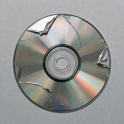 Damaged cd on plain background